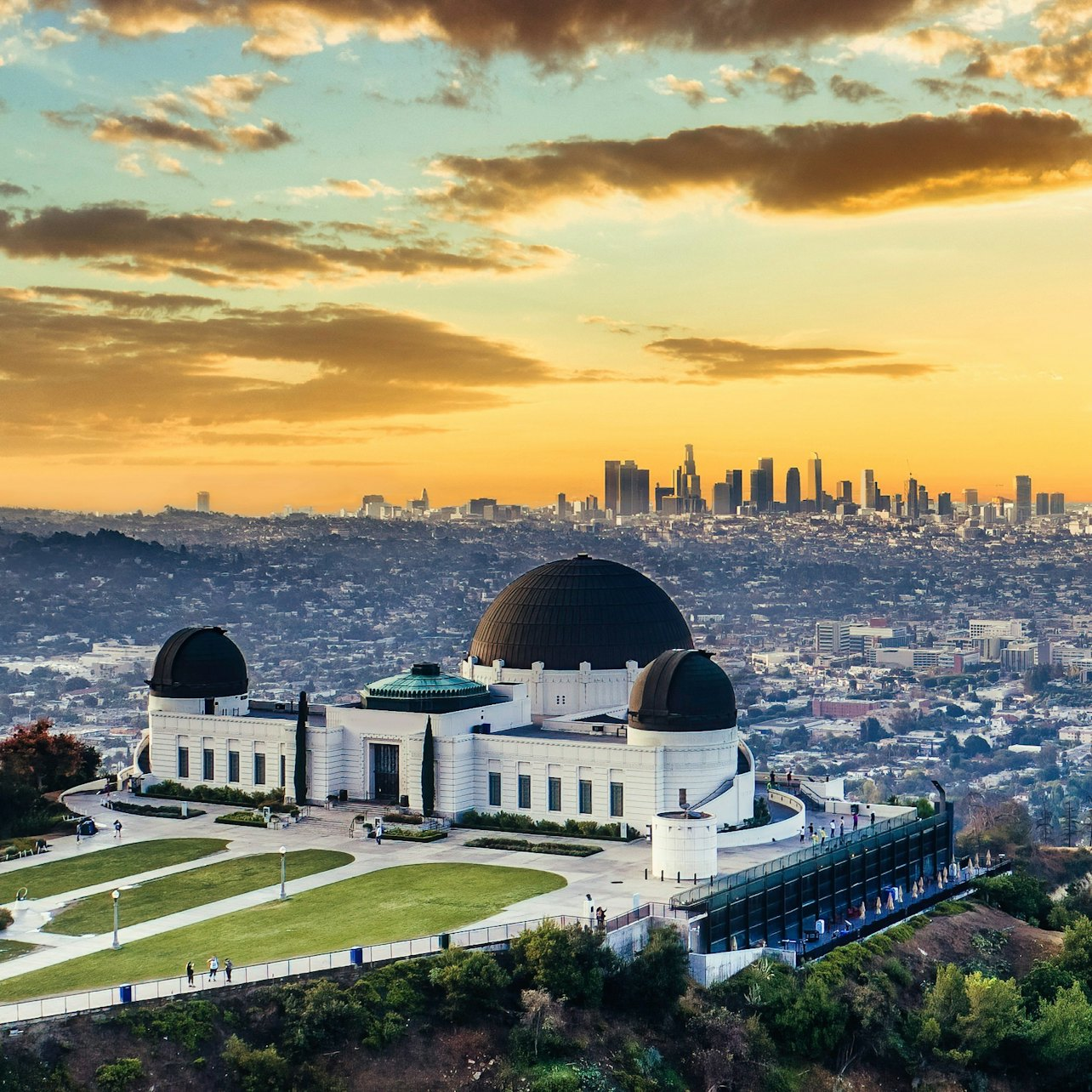 Experience stunning views of Los Angeles at sunset from Griffith Observatory where the iconic Hollywood Sign and downtown skyline come to life against a painted sky.